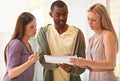 Putting their heads together. three business professionals standing and going through some paperwork together. Royalty Free Stock Photo