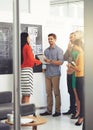 Putting their ideas on the blackboard. Full length shot of a group of businesspeople strategizing at the blackboard. Royalty Free Stock Photo