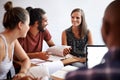 Putting there assignment in focus. Shot of a group of university students studying together.