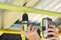 Male builder putting up ceiling battens