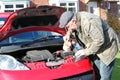 Putting water into a car radiator.