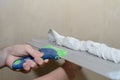 Puttying the wall with plaster putty using a wide spatula Royalty Free Stock Photo