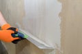 Puttying the wall with plaster putty using a wide spatula Royalty Free Stock Photo