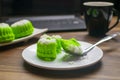 Putu ayu cake slices on a spoon on a laptop background looks blurry