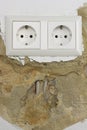 Wall plaster loosens around sockets , portrait format