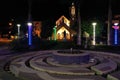 Puyo, Ecuador, 19-6-2020: night view a fontain in a public park with a church in the background Royalty Free Stock Photo