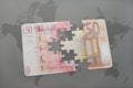 puzzle with british pound and euro banknote on a world map background.