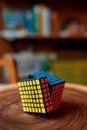 Puzzle cube 7x7 on wooden stump, closeup view