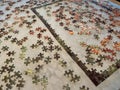 A puzzle with the edges completed on a leather looking table waiting to be finished