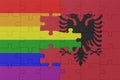 puzzle with the flag of rainbow gay pride and albania . macro.concept Royalty Free Stock Photo