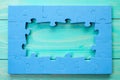Puzzle frame on blue wooden surface
