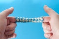 Puzzle game and logic games concept with hands playing with a chinese finger trap, a toy that the more you pull the tighter it Royalty Free Stock Photo