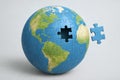 Puzzle globe with missing piece highlighting global unity and integration concept in simple composition on light background Royalty Free Stock Photo