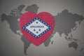 Puzzle heart with flag of arkansas state on a world map background