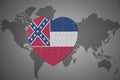 Puzzle heart with flag of mississippi state on a world map background Royalty Free Stock Photo
