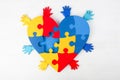 Puzzle heart hands support autism awareness Royalty Free Stock Photo