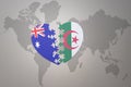 Puzzle heart with the national flag of algeria and australia on a world map background. Concept Royalty Free Stock Photo