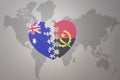 Puzzle heart with the national flag of angola and australia on a world map background. Concept Royalty Free Stock Photo