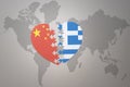 Puzzle heart with the national flag of china and greece on a world map background. Concept Royalty Free Stock Photo