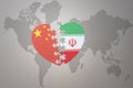 Puzzle heart with the national flag of china and iran on a world map background. Concept Royalty Free Stock Photo