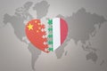 Puzzle heart with the national flag of china and italy on a world map background. Concept Royalty Free Stock Photo