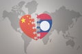 Puzzle heart with the national flag of china and laos on a world map background. Concept Royalty Free Stock Photo