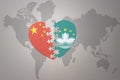 Puzzle heart with the national flag of china and Macau on a world map background. Concept Royalty Free Stock Photo