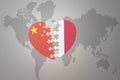 Puzzle heart with the national flag of china and malta on a world map background. Concept Royalty Free Stock Photo