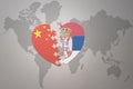 Puzzle heart with the national flag of china and serbia on a world map background. Concept Royalty Free Stock Photo