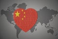 Puzzle heart with the national flag of china on a world map background Royalty Free Stock Photo