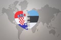 Puzzle heart with the national flag of croatia and estonia on a world map background.Concept