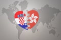 Puzzle heart with the national flag of croatia and hong kong on a world map background.Concept