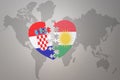 Puzzle heart with the national flag of croatia and kurdistan on a world map background.Concept