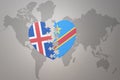 Puzzle heart with the national flag of democratic republic of the congo and iceland on a world map background. Concept Royalty Free Stock Photo