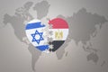 Puzzle heart with the national flag of egypt and israel on a world map background.Concept Royalty Free Stock Photo