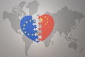 Puzzle heart with the national flag of european union and china on a world map background. Concept Royalty Free Stock Photo