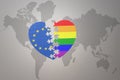 Puzzle heart with the national flag of european union and rainbow gay flag on a world map background. Concept Royalty Free Stock Photo