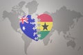 Puzzle heart with the national flag of ghana and australia on a world map background. Concept Royalty Free Stock Photo