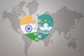 Puzzle heart with the national flag of india and Macau on a world map background.Concept Royalty Free Stock Photo