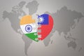 Puzzle heart with the national flag of india and taiwan on a world map background.Concept Royalty Free Stock Photo