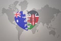 Puzzle heart with the national flag of kenya and australia on a world map background. Concept Royalty Free Stock Photo