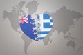 Puzzle heart with the national flag of new zealand and greece on a world map background. Concept