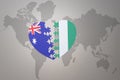 Puzzle heart with the national flag of nigeria and australia on a world map background. Concept Royalty Free Stock Photo