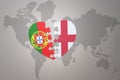 Puzzle heart with the national flag of portugal and england on a world map background.Concept
