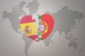 Puzzle heart with the national flag of portugal and spain on a world map background. Concept Royalty Free Stock Photo