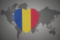 Puzzle heart with the national flag of romania on a world map background