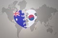 Puzzle heart with the national flag of south korea and australia on a world map background. Concept Royalty Free Stock Photo