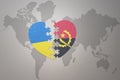 Puzzle heart with the national flag of ukraine and angola on a world map background. Concept Royalty Free Stock Photo