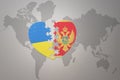 Puzzle heart with the national flag of ukraine and montenegro on a world map background. Concept