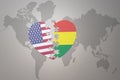 Puzzle heart with the national flag of united states of america and bolivia on a world map background. Concept Royalty Free Stock Photo